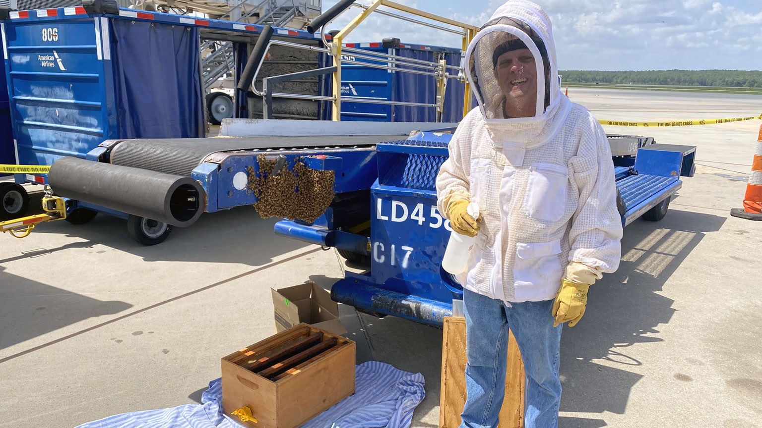 Tom Kwak helps move bees at RDU