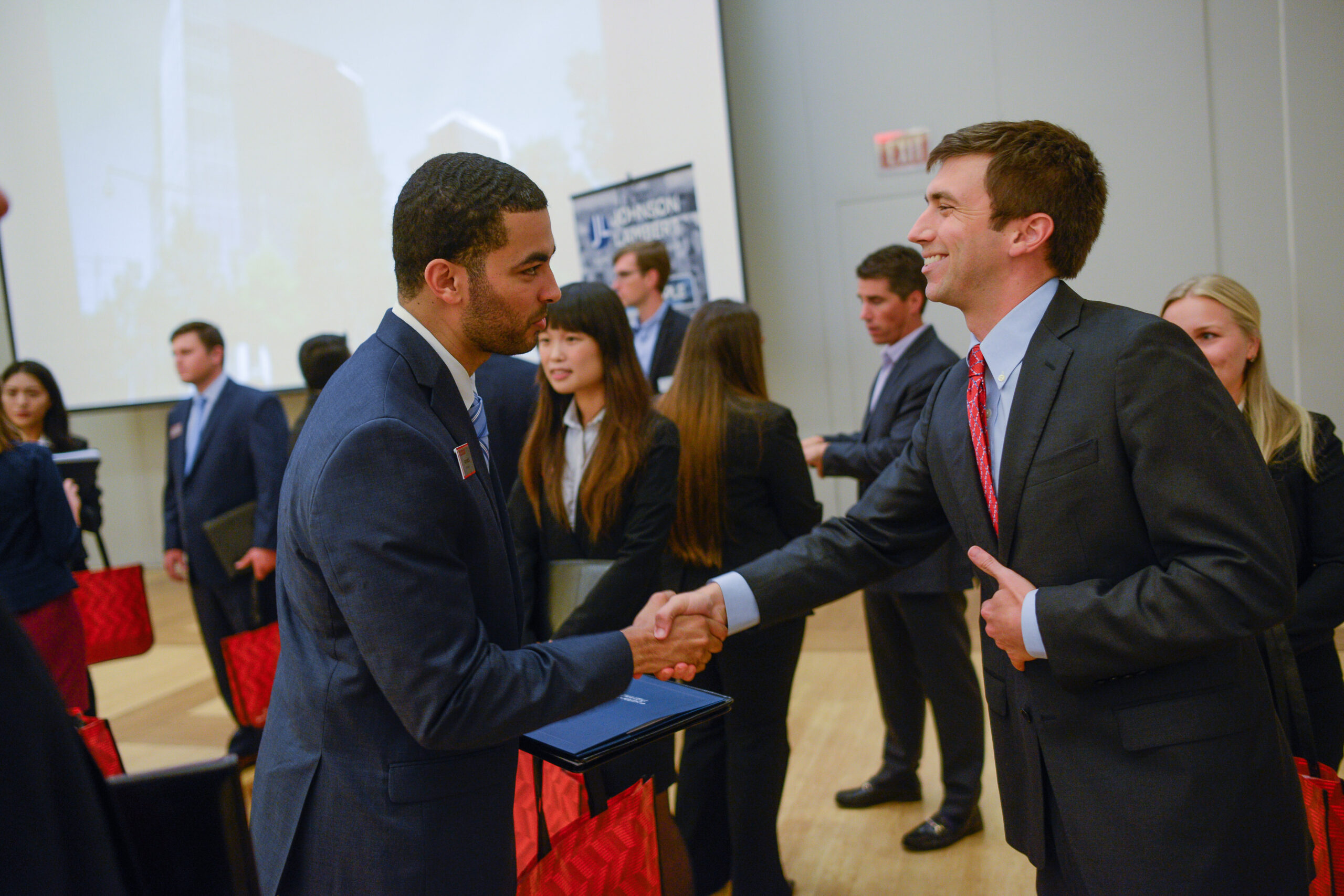 Serves as a link to the Industry Partnership Page - students meeting potential employers in industry