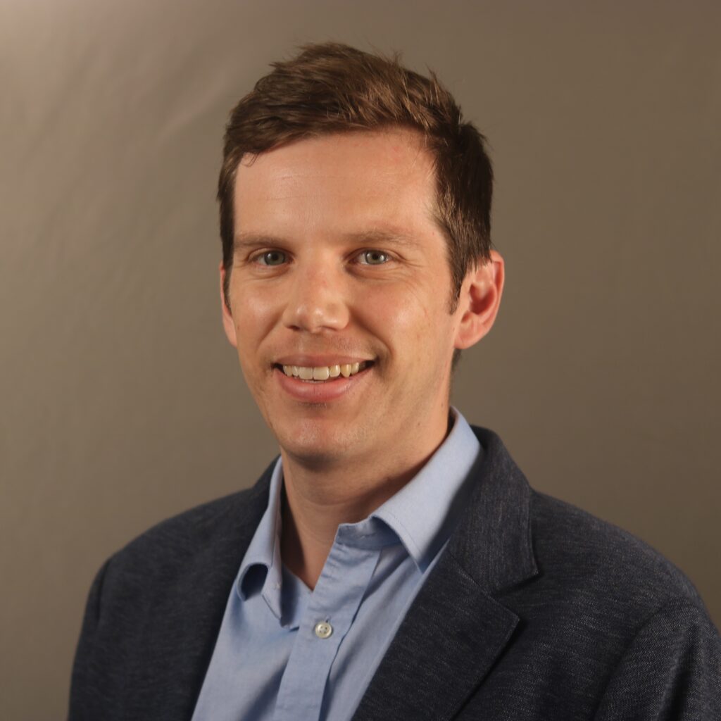 a man smiles at the camera